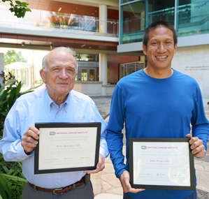 Doctors Jeffrey Berenberg and Jared Acoba holding their certificates of recognition