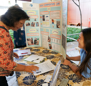 Participant at a display booth at the 8th Annual Quest for a Cure