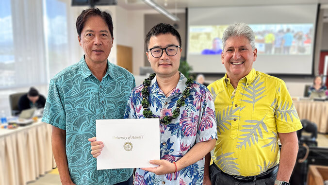 Lang Wu, center, with Board of Regents Chair Gabriel Lee, left, and UH President David Lassner, right.