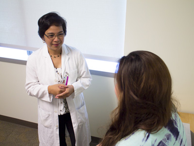 A clinician speaking with a cancer patient